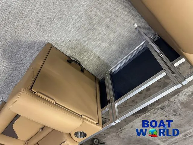 Slide: The Image of Interior of 2025 Tahoe Sport 23' Fish & Cruise boat with tan seating and storage. - 25