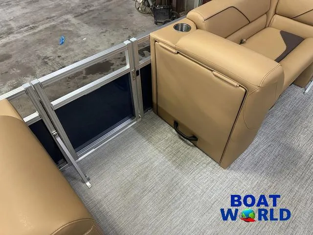 Slide: The Image of Interior of 2025 Tahoe Sport 23' Fish & Cruise boat with tan seating and cup holder. - 26