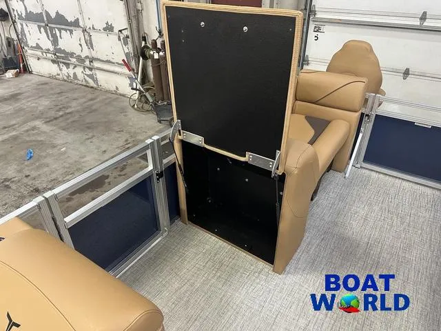 Slide: The Image of 2025 Tahoe Sport 23' Fish & Cruise interior with tan seating and storage compartment. - 27