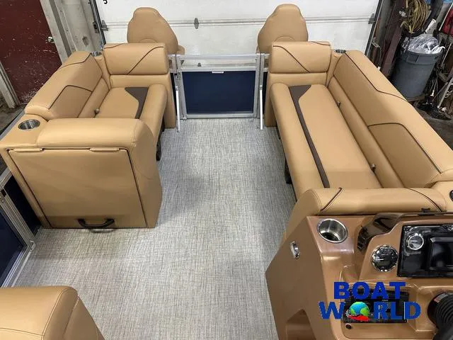 Slide: The Image of 2025 Tahoe Sport 23' Fish & Cruise interior with tan seating and modern dashboard. - 28