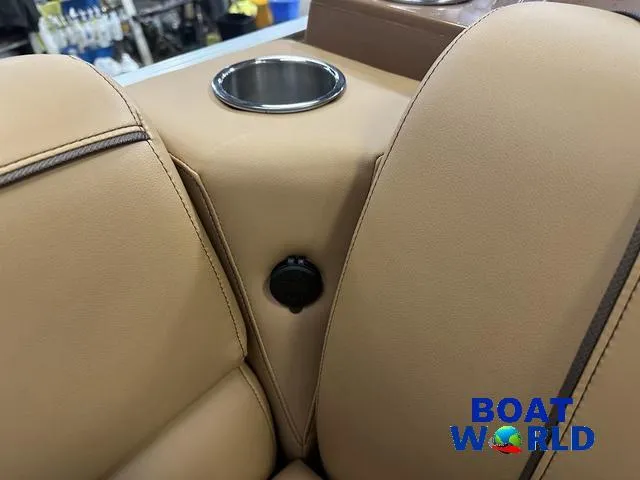 Slide: The Image of 2025 Tahoe Sport 23' Fish & Cruise boat interior with cup holder, tan upholstery. - 29