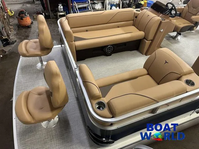 Slide: The Image of 2025 Tahoe Sport 23' Fish & Cruise boat interior with tan seating and cup holders. - 3