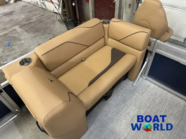 Slide: The Image of 2025 Tahoe Sport 23' Fish & Cruise boat interior with tan seating and cup holders. - 31