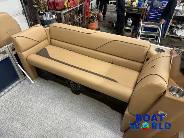 Slide: The Image of 2025 Tahoe Sport 23' Fish & Cruise boat interior with tan seating and cup holders. - 32