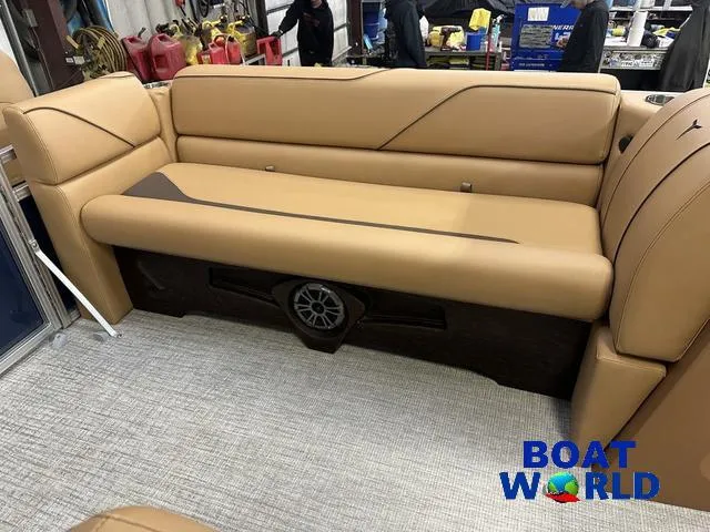 Slide: The Image of 2025 Tahoe Sport 23' Fish & Cruise boat interior with tan seating and speaker system. - 33