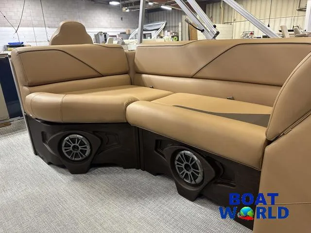 Slide: The Image of 2025 Tahoe Sport 23' Fish & Cruise boat interior with tan seating and built-in speakers. - 36