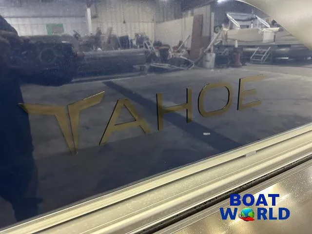 Slide: The Image of 2025 Tahoe Sport 23' Fish & Cruise boat logo in showroom, Boat World branding. - 42