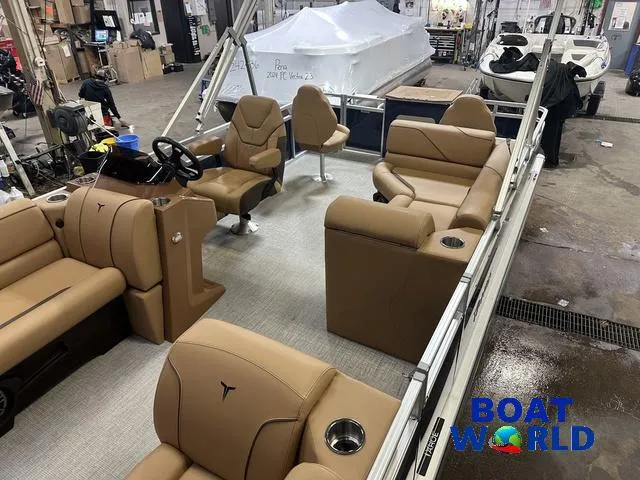 Slide: The Image of 2025 Tahoe Sport 23' Fish & Cruise boat interior with tan seating in a showroom. - 5