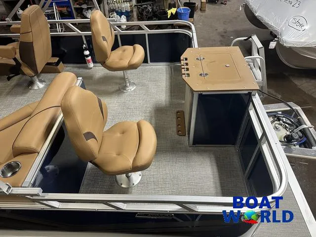 Slide: The Image of 2025 Tahoe Sport 23' Fish & Cruise boat interior with tan seats and fishing station. - 6