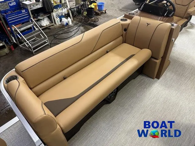 Slide: The Image of 2025 Tahoe Sport 23' Fish & Cruise boat interior with tan seating, showcased at Boat World. - 9