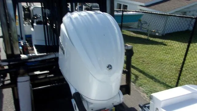 Slide: The Image of 2025 Sportsman Masters 247 boat engine on a trailer in a residential area. - 12