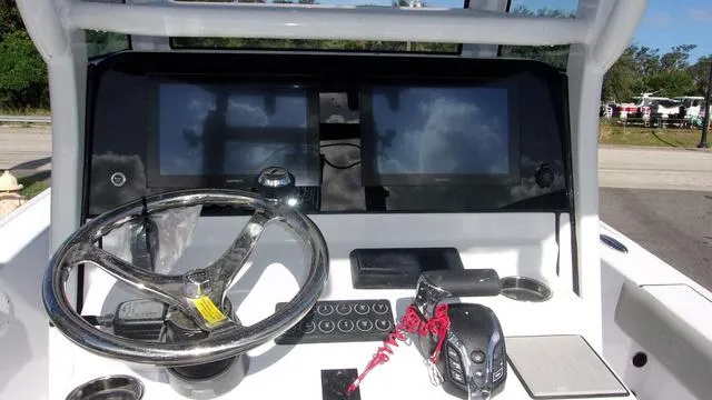 Slide: The Image of Dashboard of 2025 Sportsman Masters 247 boat with steering wheel and electronic controls. - 7