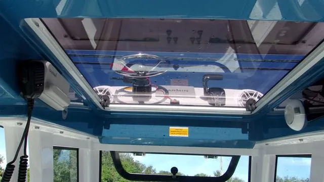 Slide: The Image of Interior view of 2025 Sportsman Masters 247 boat with glass roof and electronic equipment. - 8