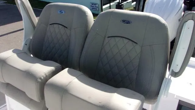 Slide: The Image of 2025 Sportsman Masters 247 boat seats with diamond stitching and armrests. - 9
