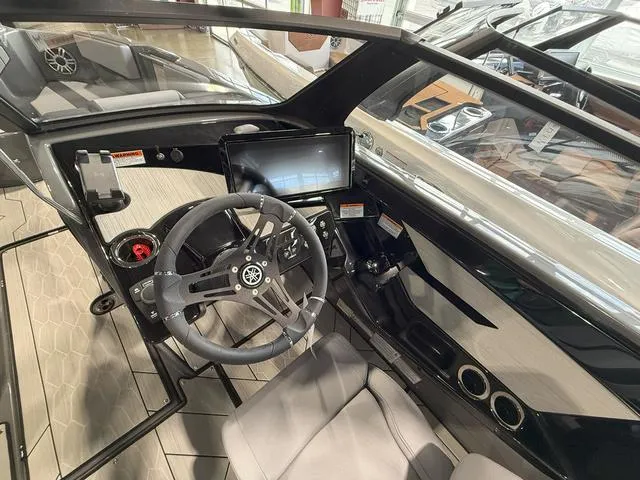 Slide: The Image of 2025 Yamaha Boats 222XE interior with steering wheel and dashboard display. - 11