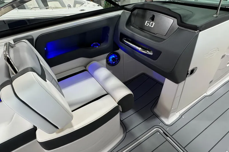 Slide: The Image of 2025 Chaparral 247 SSX boat interior with modern dashboard and seating. - 13