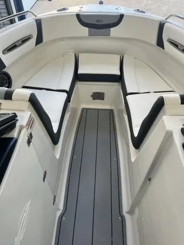 Slide: The Image of 2025 Chaparral 247 SSX boat interior with sleek seating and modern dashboard design. - 6