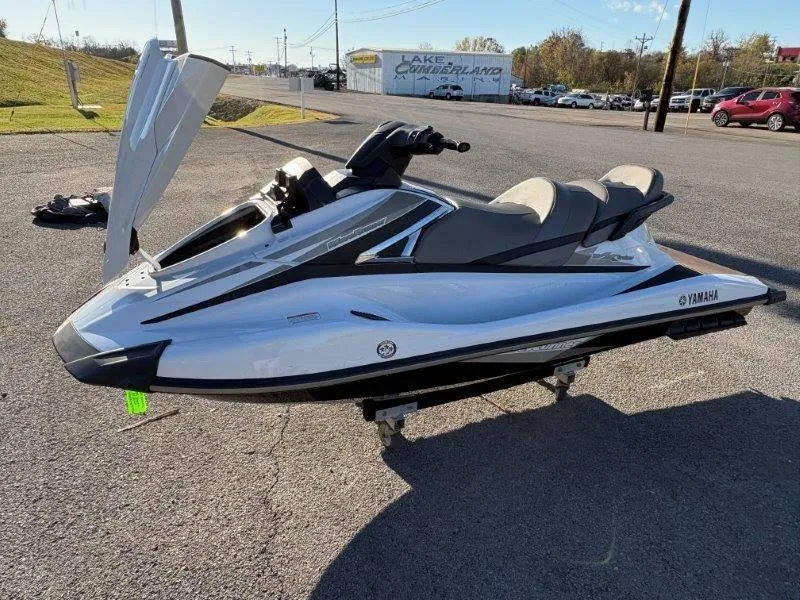 Slide: The Image of 2015 Yamaha Waverunner VX Cruiser jet ski on display in a parking lot. - 25