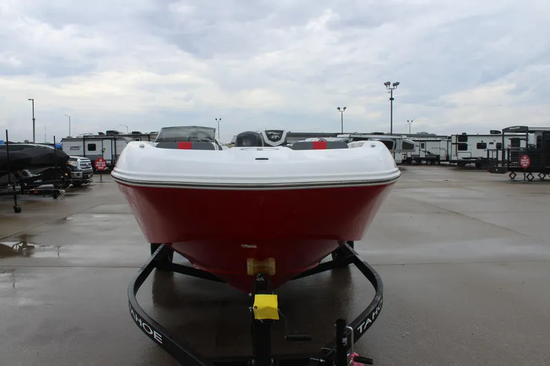 Slide: The Image of 2025 Tahoe T18 boat in a parking lot, front view, overcast sky. - 2