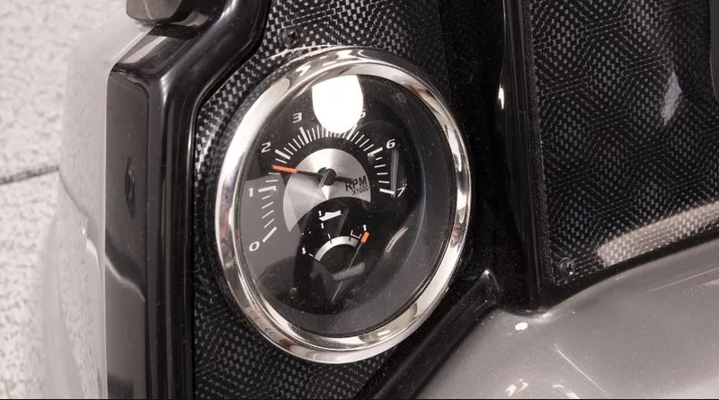 Slide: The Image of Close-up of 2023 G3 Sportsman 1610 dashboard gauge with carbon fiber detail. - 9