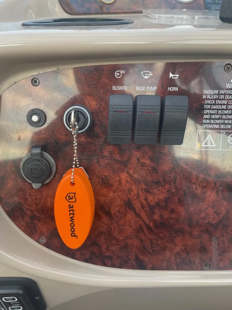 Slide: The Image of Dashboard of 2005 Four Winns 248 Vista boat with ignition key and switches. - 10