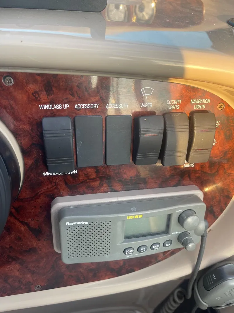 Slide: The Image of Control panel of 2005 Four Winns 248 Vista boat with switches and Raymarine device. - 12