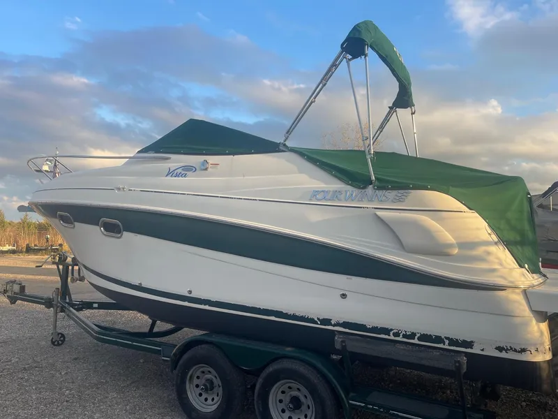 Slide: The Image of 2005 Four Winns 248 Vista boat with green canopy on trailer. - 2