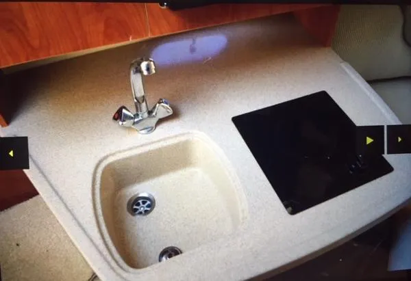 Slide: The Image of 2005 Four Winns 248 Vista boat kitchenette with sink and stove. - 20