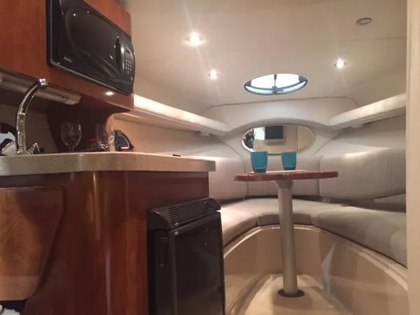 Slide: The Image of 2005 Four Winns 248 Vista boat interior with kitchenette and seating area. - 23