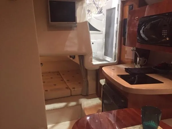 Slide: The Image of Interior of 2005 Four Winns 248 Vista boat with kitchenette and seating area. - 24