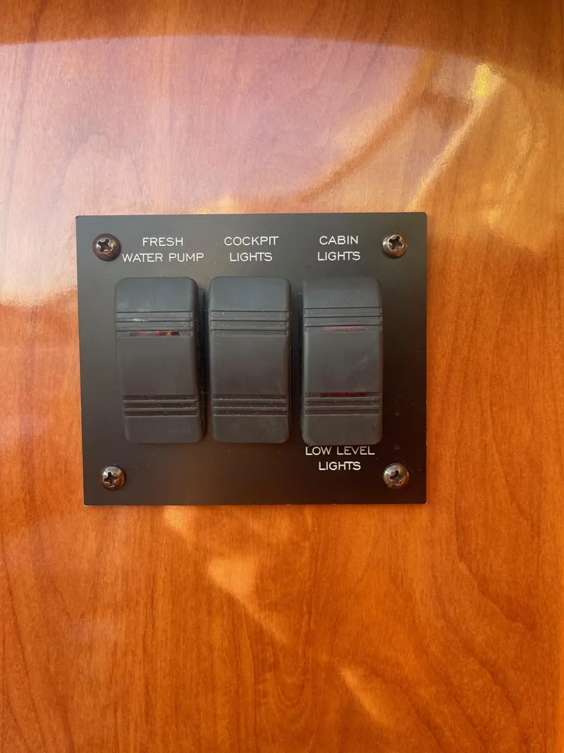 Slide: The Image of 2005 Four Winns 248 Vista control panel with switches for water pump and lights. - 25