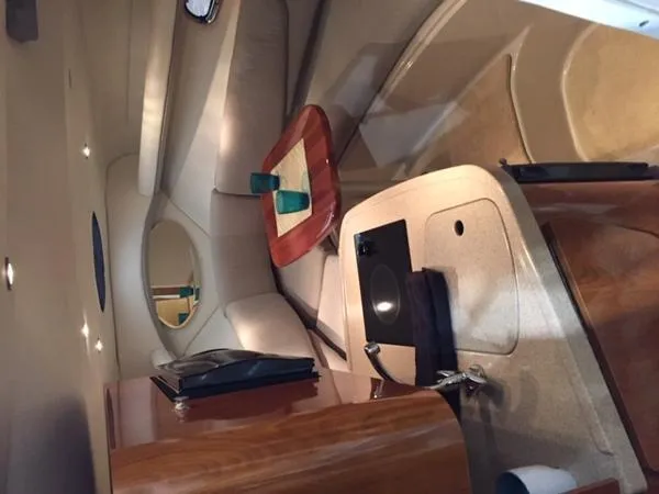Slide: The Image of Interior of 2005 Four Winns 248 Vista boat with cozy seating and table. - 26