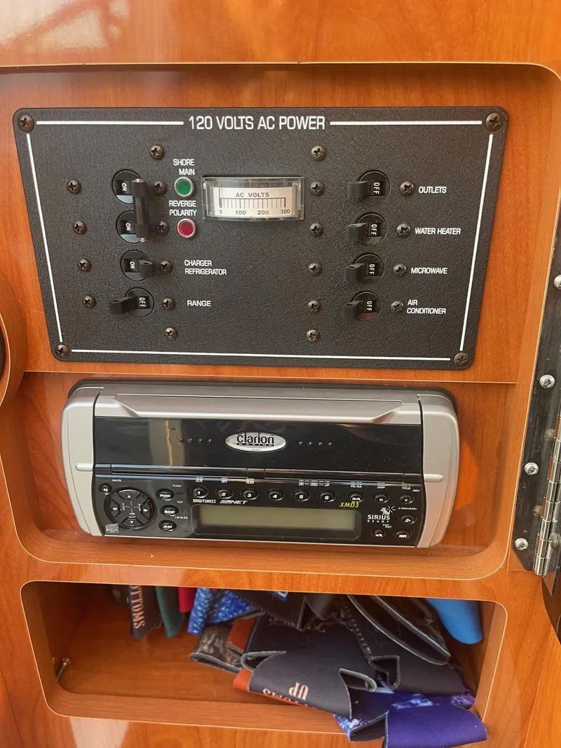 Slide: The Image of 2005 Four Winns 248 Vista control panel with AC power and stereo system. - 27