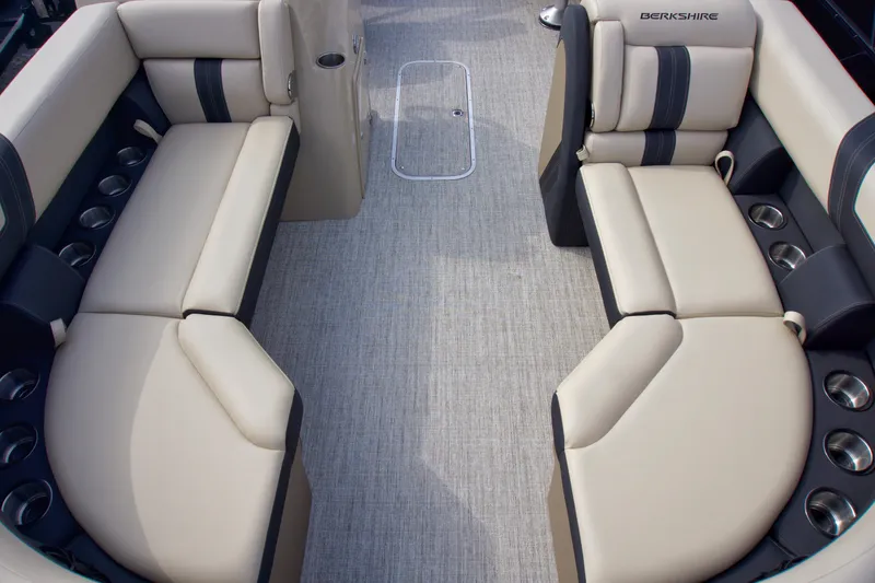 Slide: The Image of 2025 Berkshire 24RFXCTS275 boat interior with beige seating and cup holders. - 3