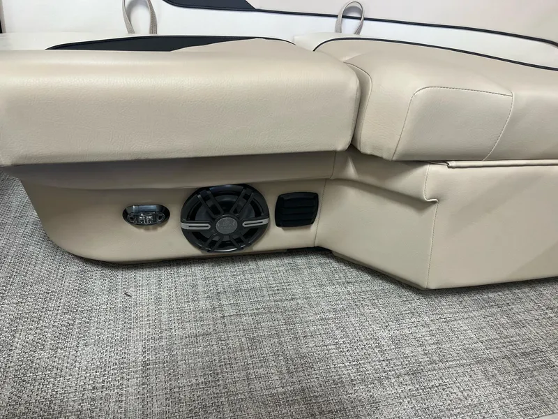 Slide: The Image of 2024 G3 SunCatcher X320 Cruise boat interior with beige seating and speaker system. - 20