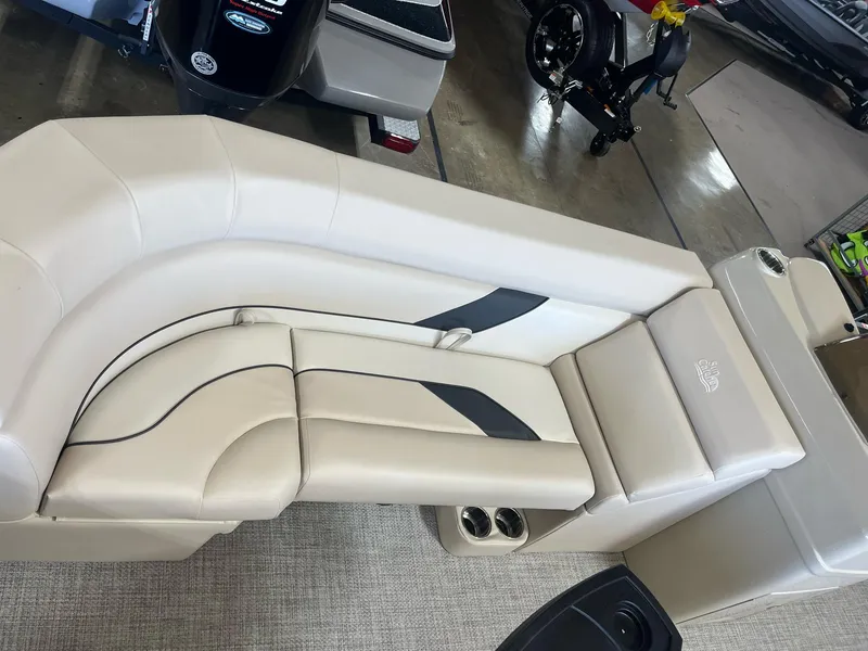 Slide: The Image of 2024 G3 SunCatcher X320 Cruise boat interior with beige seating and cup holders. - 6