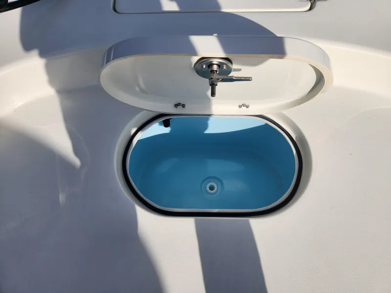 Slide: The Image of Pathfinder 2600 HPS 2025 boat livewell with open lid, showing blue interior. - 15