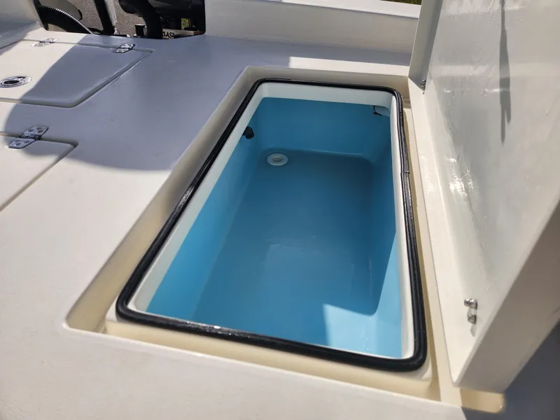 Slide: The Image of 2025 Pathfinder 2600 HPS boat livewell with open lid, showcasing interior. - 32
