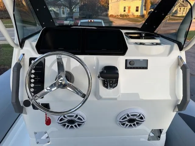 Slide: The Image of 2025 Brig Eagle 8 boat dashboard with steering wheel and controls. - 15