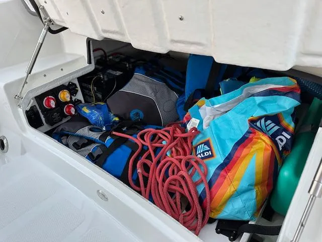 Slide: The Image of Storage compartment of 2025 Brig Eagle 8 boat filled with colorful gear and ropes. - 19