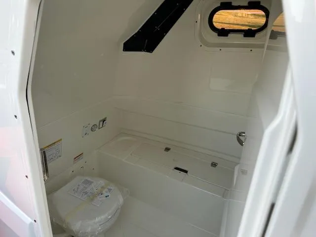 Slide: The Image of Interior of 2025 Brig Eagle 8 boat, featuring a compact bathroom with a toilet. - 21