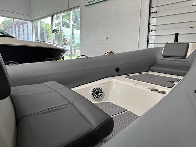 Slide: The Image of 2025 Brig Eagle 8 boat interior with gray seating and modern design in a showroom. - 22