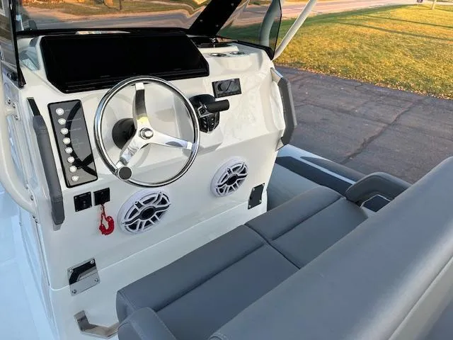 Slide: The Image of 2025 Brig Eagle 8 boat dashboard with steering wheel and seating. - 29