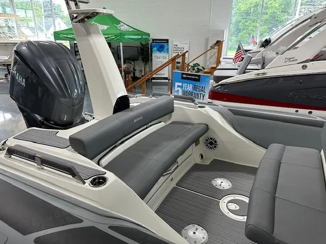 Slide: The Image of 2025 Brig Eagle 8 boat interior with Yamaha engine, showcasing seating and warranty sign. - 3