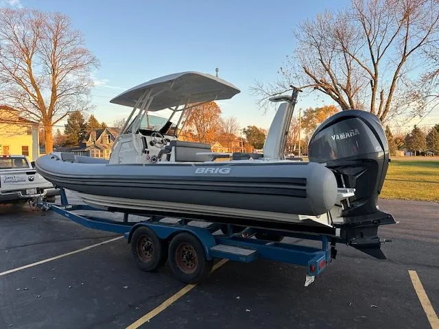 Slide: The Image of 2025 Brig Eagle 8 boat on trailer with Yamaha engine in a parking lot. - 7