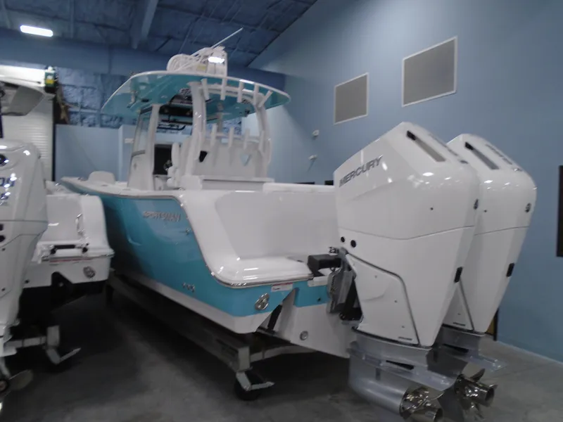 Slide: The Image of 2024 Sportsman Open 302 Center Console boat with dual Mercury engines in a showroom. - 5