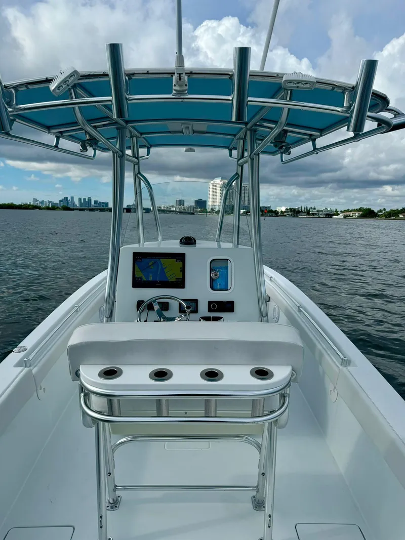 Slide: The Image of 2023 Contender Center Console boat on water, featuring modern navigation equipment. - 10