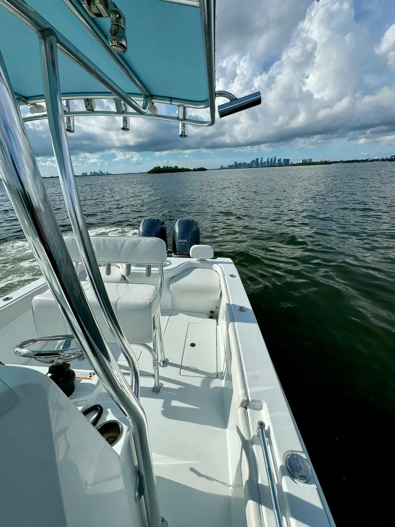 Slide: The Image of 2023 Contender Center Console boat on open water with city skyline in background. - 11