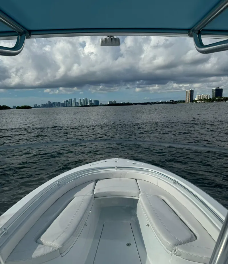 Slide: The Image of 2023 Contender Center Console boat on open water with city skyline in background. - 13