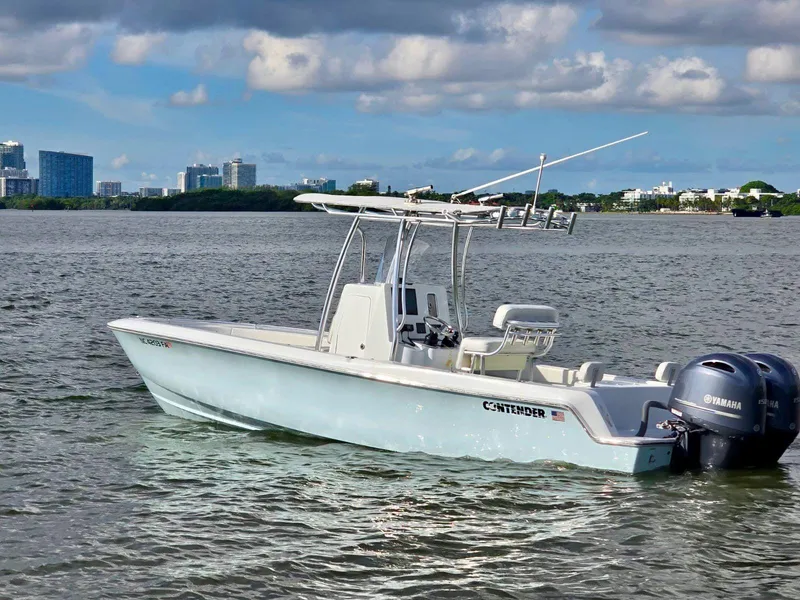 Slide: The Image of 2023 Contender Center Console boat on water with city skyline in background. - 2